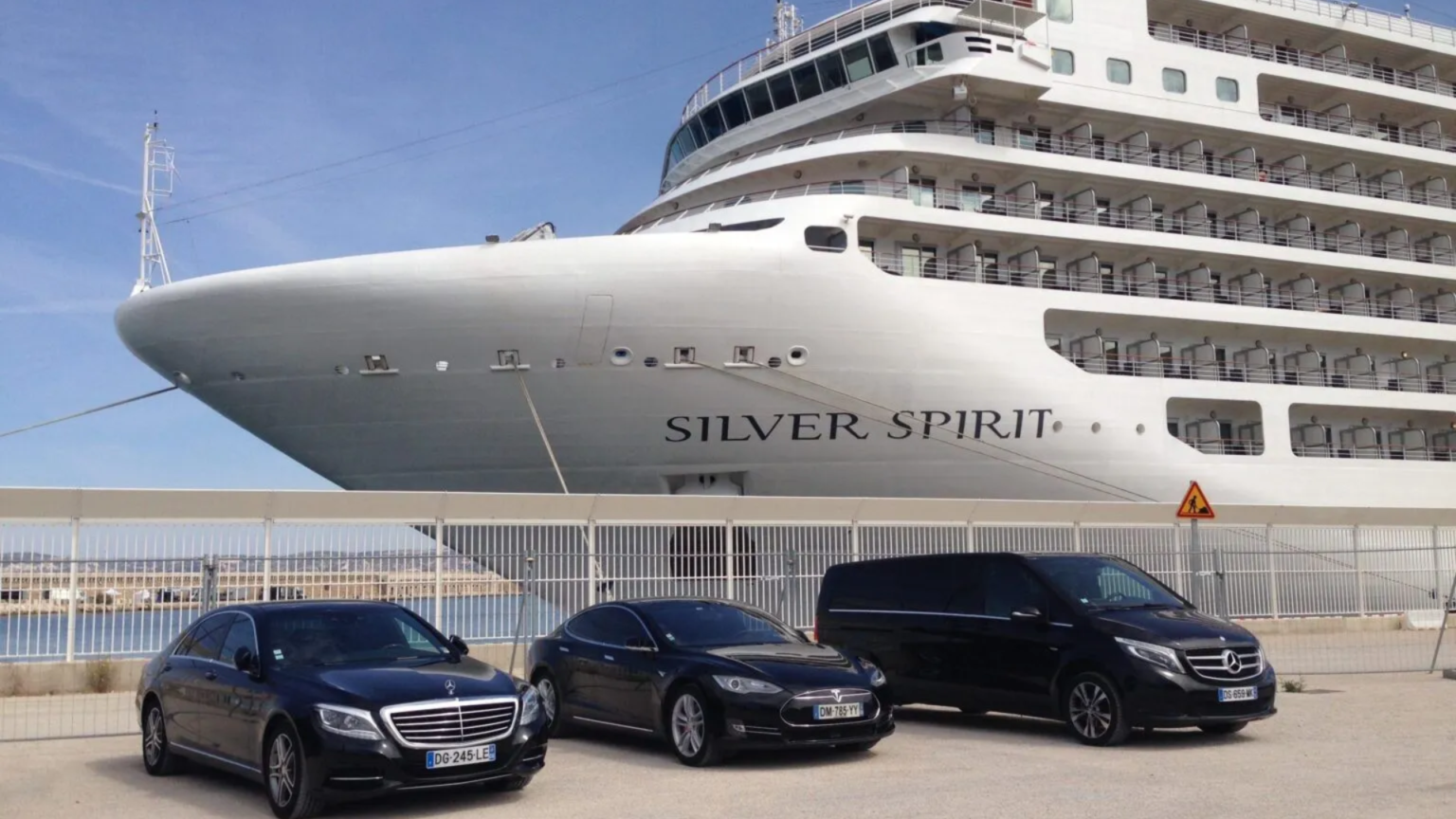 3 limousines of various sizes parked in front of a Silversea cruise ship