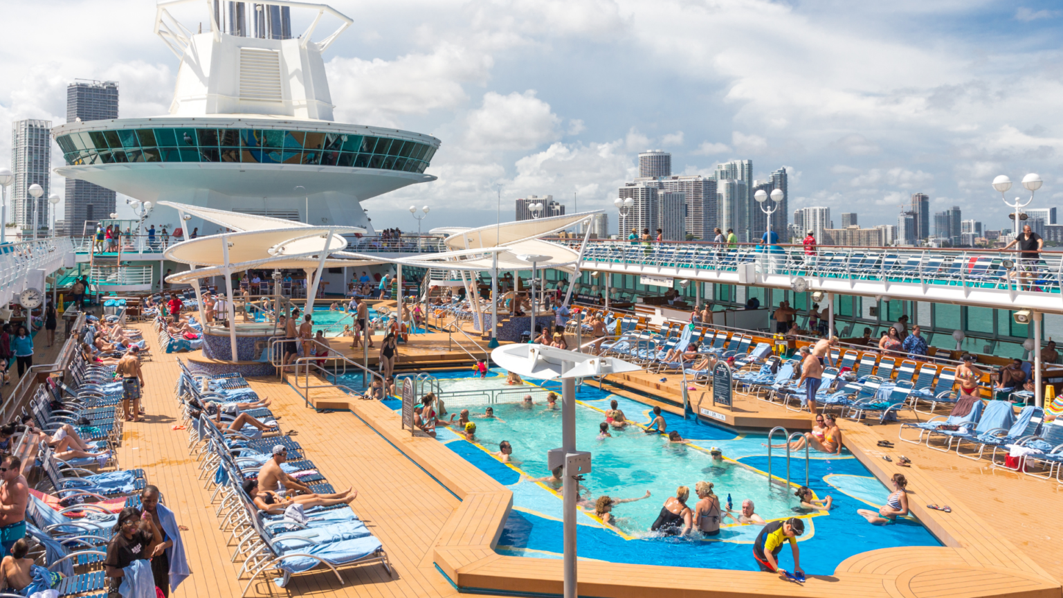 Wide angle shot of a big crowd enjoying a pool on a Royal Caribbean cruise ship